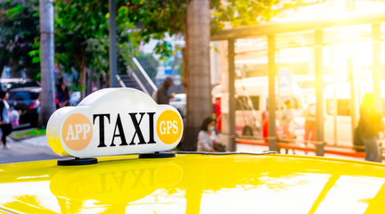 Taxi cabs stopped waiting for passengers with Sunlight shines on the station. close up a taxi sign...