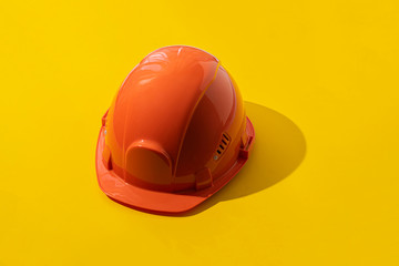 the simple orange head helmet, abstract minimalistic concept of the safety job