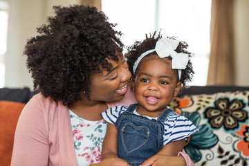 African American family. Mother and daughter smiling at home.
