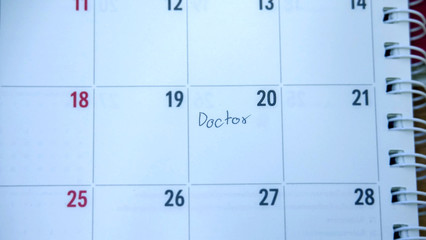 Close up Calendar in diary book planner to remind important appointment to see Doctor. medical concept
