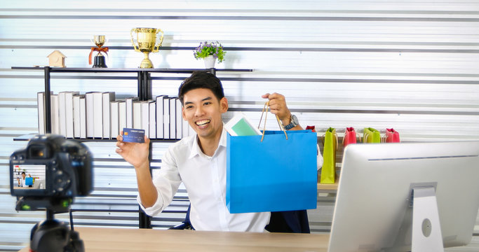 Asian man  blogger broadcasting a video for selling product online .Shopping online concept.