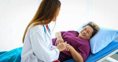 Fototapeta premium Doctor meeting and explaining medication to old woman patient at Hospitals