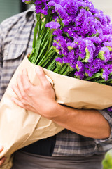 Male florist holding flowers