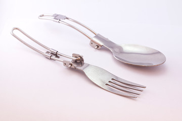 Pocket spoon and fork on white