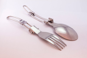 Pocket spoon and fork on white