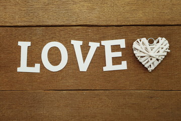 LOVE alphabet letter with Heart on wooden background