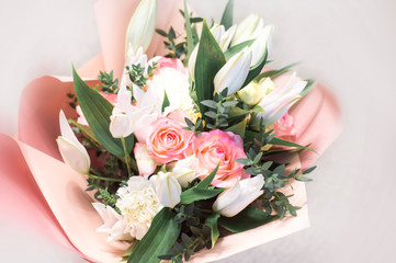 Delicate bouquet of flowers close-up. Roses and lilies.