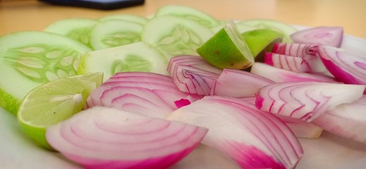 sliced red onion on wooden background