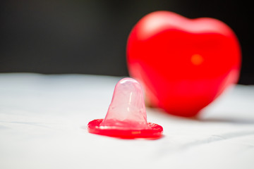 Condom and stethoscope,and red heart 