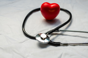 Medical stethoscope and red heart.