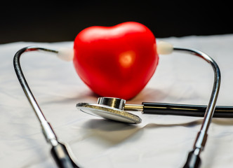 Medical stethoscope and red heart.