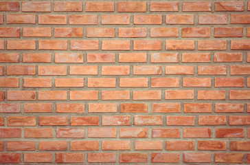 Old Orange brick wall concrete or stone texture background, wallpaper limestone abstract to flooring and homework/Brickwork or stonework clean grid uneven interior rock old. Copy space.