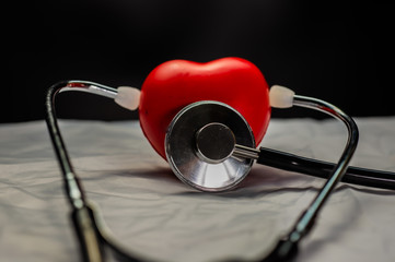 Medical stethoscope and red heart.