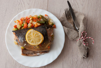 Trout steaks in a white plate placed on the table and served