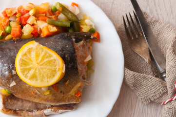 Trout steaks in a white plate placed on the table and served
