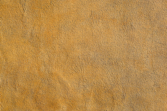 Background from a wall of ocre plaster