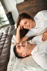 A young married couple awaiting a baby. Beautiful couple lying in the bedroom make plans for the...