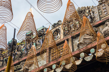 Burning spiral incense sticks hanging from the ceiling of Chua Ba Thien Hau pagoda in Ho Chi Minh,...