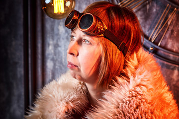 Ugly strange girl in unusual glasses in a strange dark room with a clock on the wall and the light...