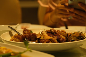 Beef stew with potatoes, carrots and herbs on black background with copy space, side view