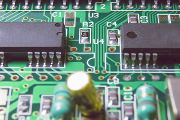 Green electronic board with chips and components.