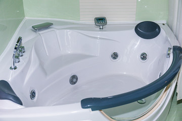 Simple bathroom interior with white vanity cabinet and hardwood floor.