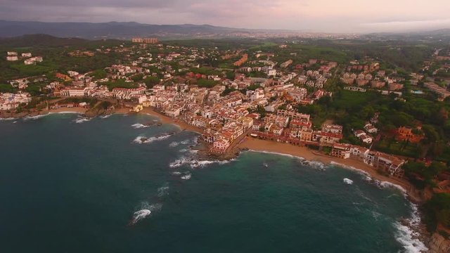 Aerial Drone Shot of Calella de Palafrugell Coastline and City During Sunrise
