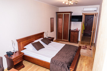 Interior of hotel apartment, bedroom. Luxury or classic bedroom with warm light of hotel resort.