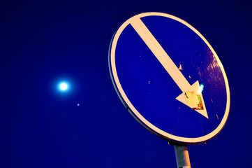 Road sign Obstacle Detour in the evening with bright moon