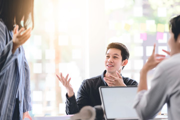 Business people discussing, talking and smiling during conference in modern office.