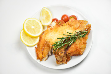 fried fish fillet sliced for steak or salad cooking food with herbs spices rosemary and lemon...