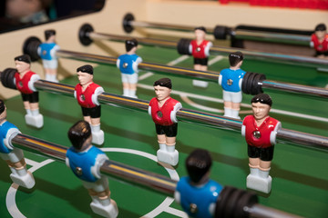 Friends Playing Table Soccer Game. table football or kicker with miniature players. game table. Games, entertainment, hobbies and leisure.foosball.plastic players in the table soccer.game kicker