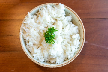 Small bowl of white rice with vegetable decorated on top.