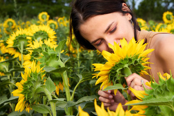 Young girl in a sunflowers field with sunflowers