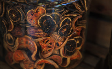 dried sliced preserved Bael fruit (quince) stored in glass jar. It is used for making preserves or jelly, food ingredient. Traditional medicine, herbal drink, health benefit for cough relief concept