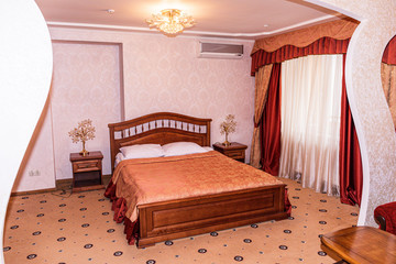 Interior of hotel apartment, bedroom. Luxury or classic bedroom with warm light of hotel resort.