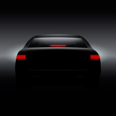 Black car with back red lights on dark background.
