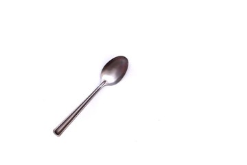 Small stainless glossy spoon on white isolated background 
