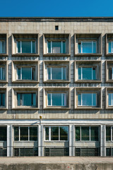 Fototapeta premium Wall with windows fragment ofl building in Saint-Petersburg, Russia, Soviet modernism brutalism