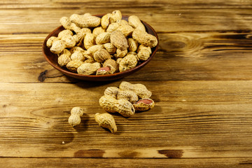 Peanuts in nutshell on a wooden table