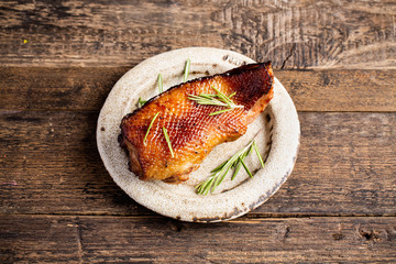 Smoked roasted goose carpaccio on wooden table with garnish green salad