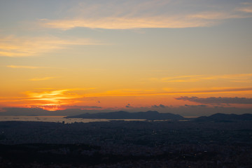 Fototapeta na wymiar Sunset in Athens on a cloudy sky with a city view from Lycabettus hill