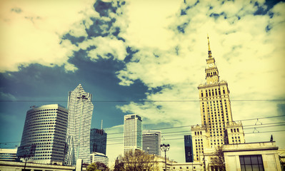 Fototapeta na wymiar Panorama of Warsaw with modern skyscrapers on a sunny day overlooking the Palace of Culture. Old retro vintage style photo.