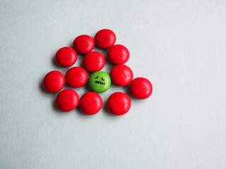 a stressed face being bullied by a group of different color because of differences.