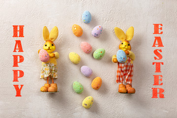 Easter. Easter bunnies and eggs on a light concrete background.