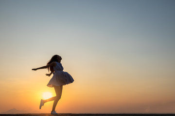 Young asia woman jumping in the sky and feeling free,happy