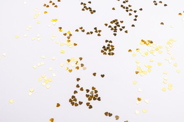 Beautiful light background with gold sequins hearts