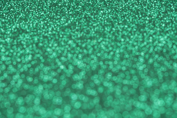Beautiful green background of unfocused sequins and glitter