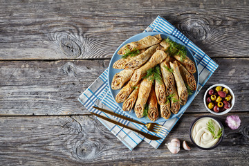 buckwheat crepe rolls with meat, veggies, flat lay