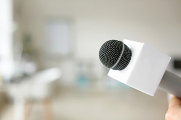 Fototapeta premium Journalist's microphone in office, closeup